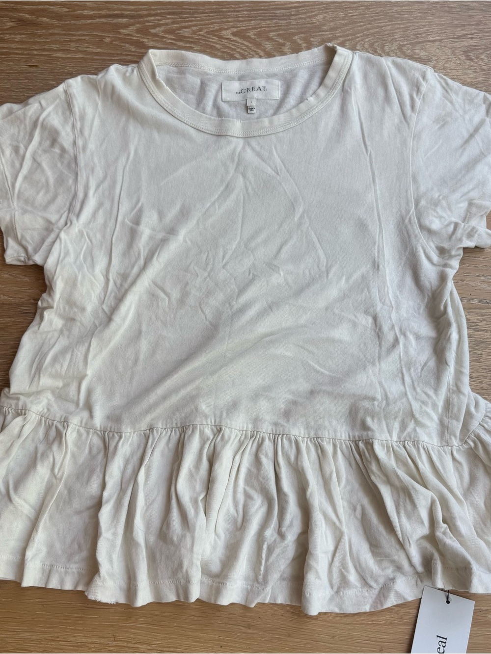 The GREAT cream peplum distressed tee